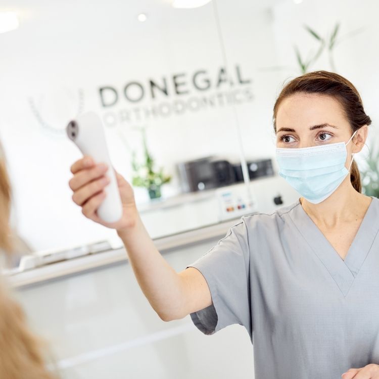 Orthodontic Assistant, Orla taking an orthodontic patients temperature at Donegal Orthodontics